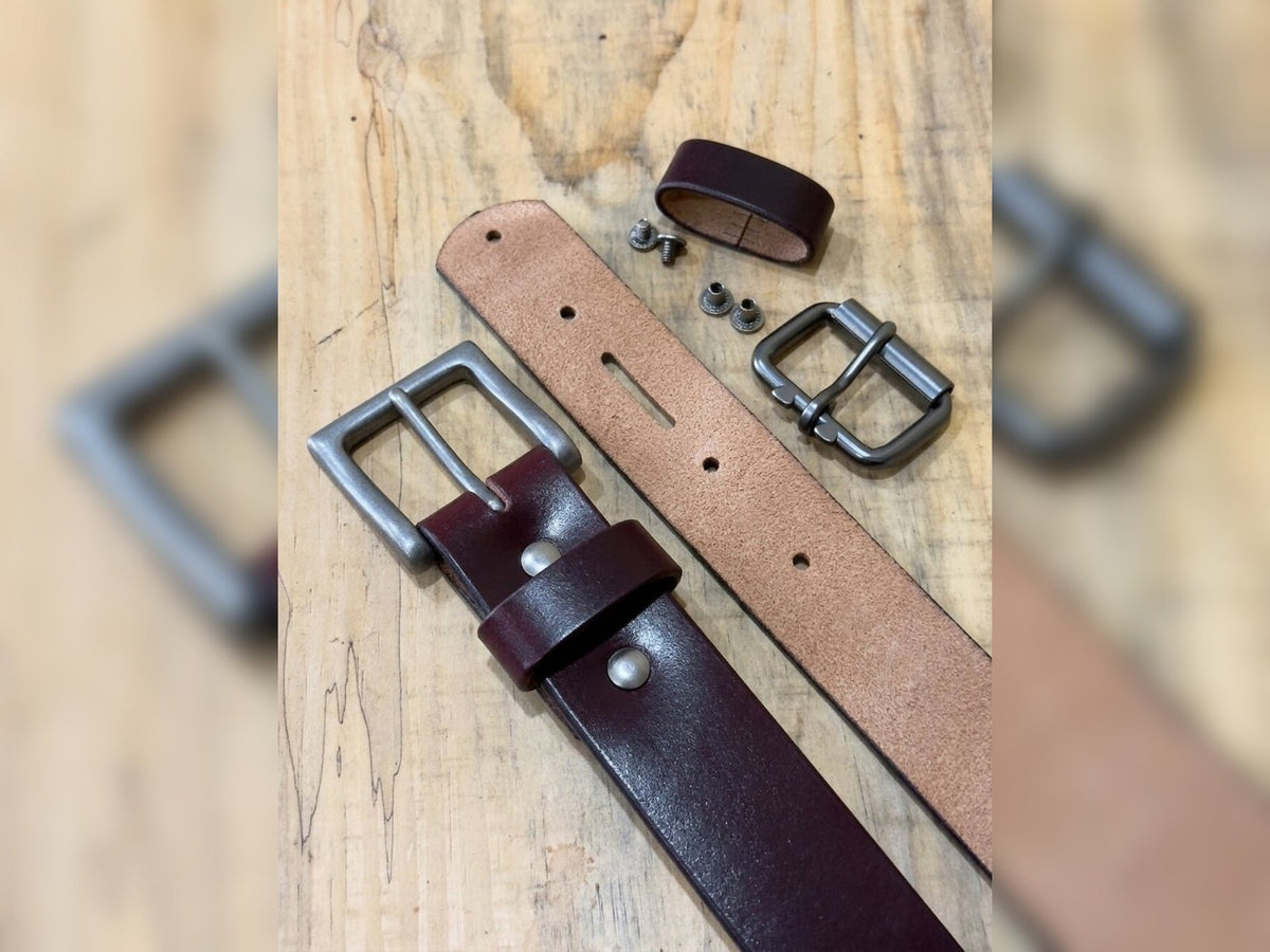 Dark burgundy latigo belt with removable buckle, keeper, and Chicago screws displayed