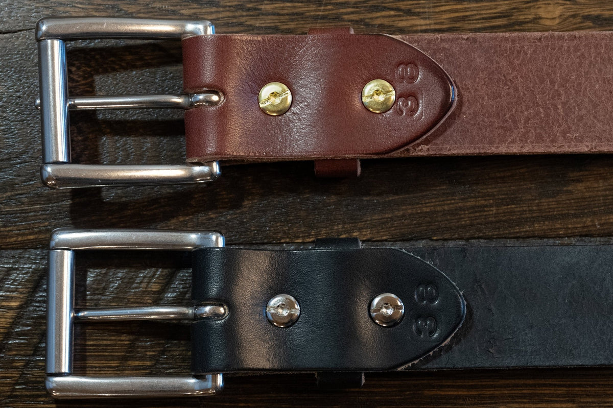 Back of black and brown Maverick raw-edge leather belts showing Chicago screw buckle attachments and size stamps.