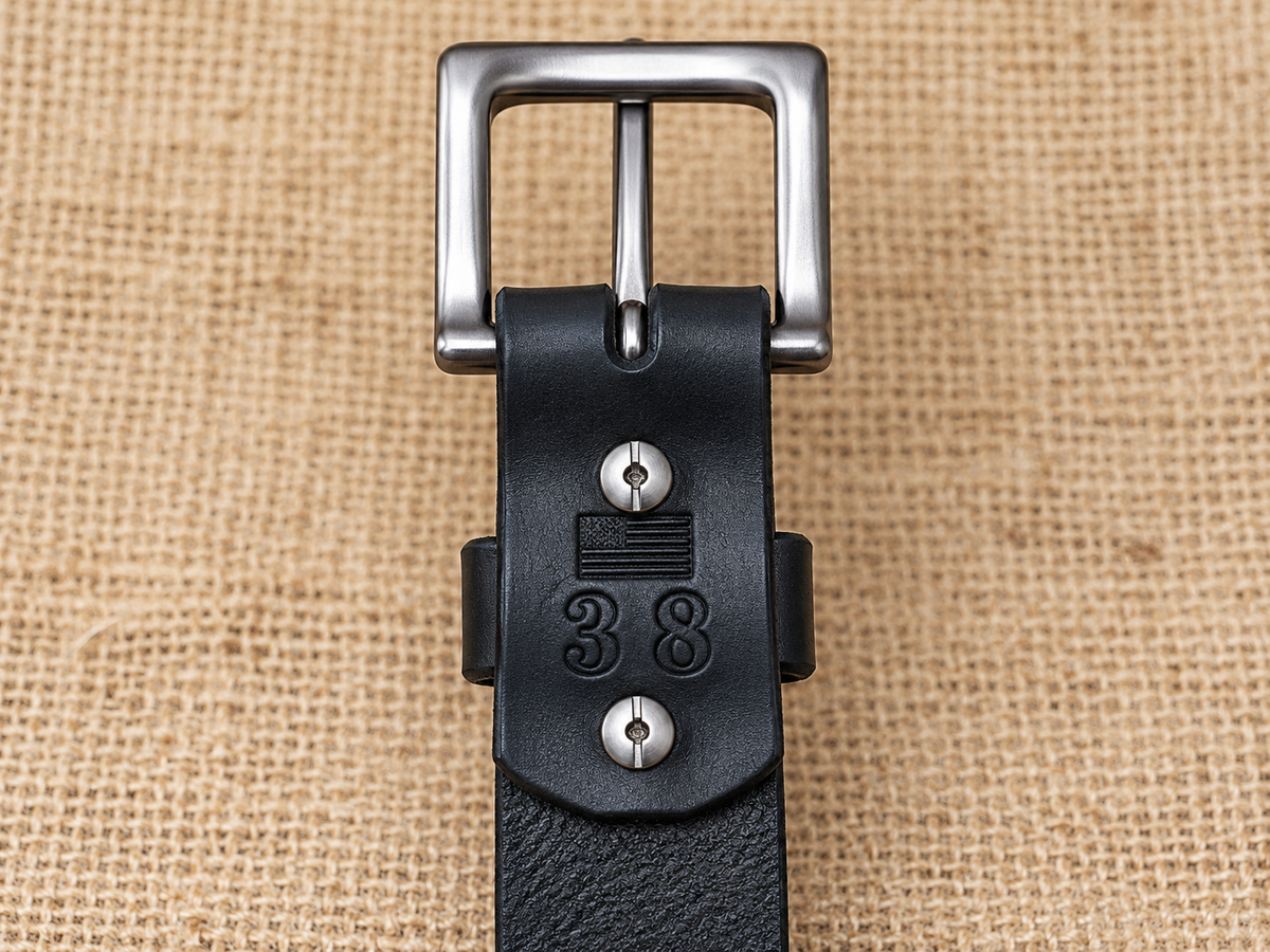 Full Grain Black Latigo Leather Belt underside showing Chicago screws, buckle attachment, and size 38 stamp.