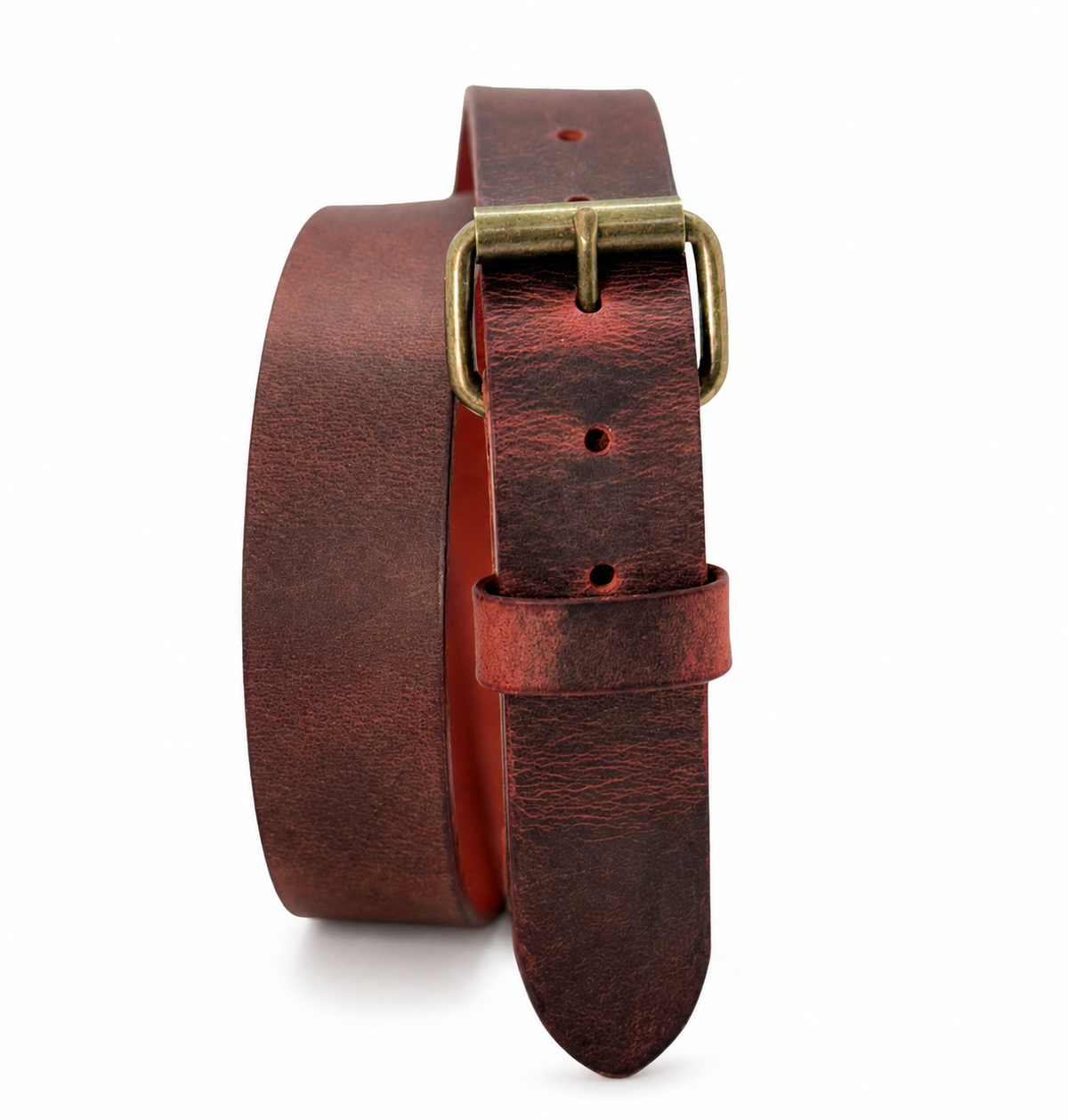 Chestnut Crazy Horse leather belt standing coiled with an antique brass roller buckle, showing its reddish-brown pull-up finish.
