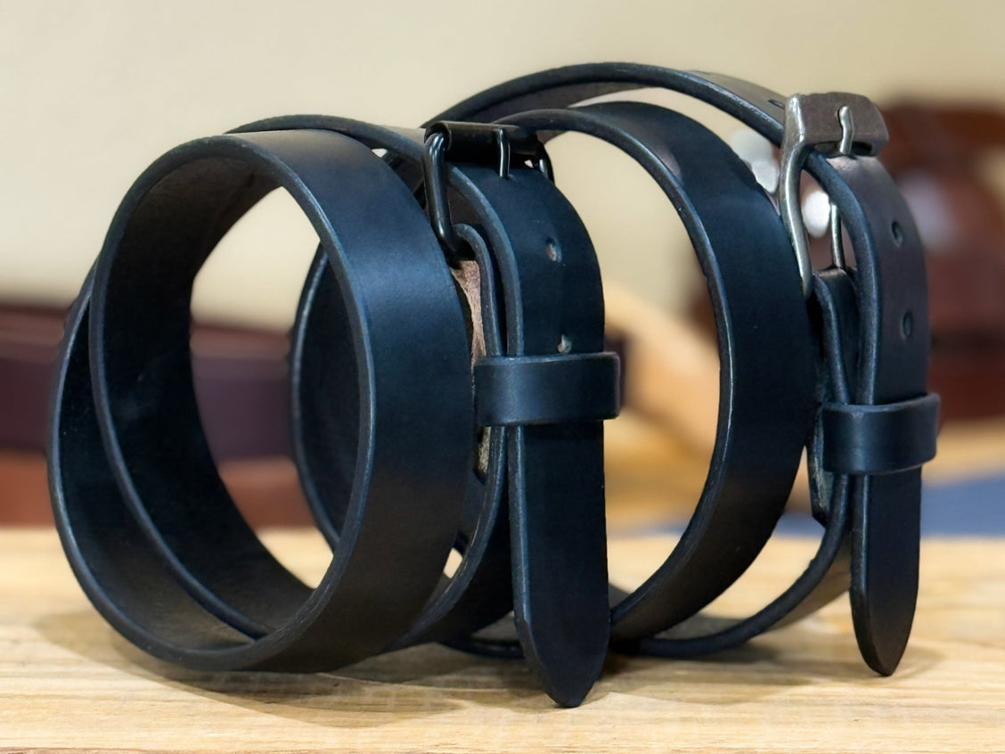 Black 13–14oz harness belt laid flat to show fitting holes and heavy strap.
