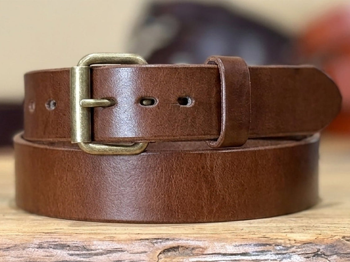 Brown 13–14oz harness belt laid flat to show fitting holes and heavy strap