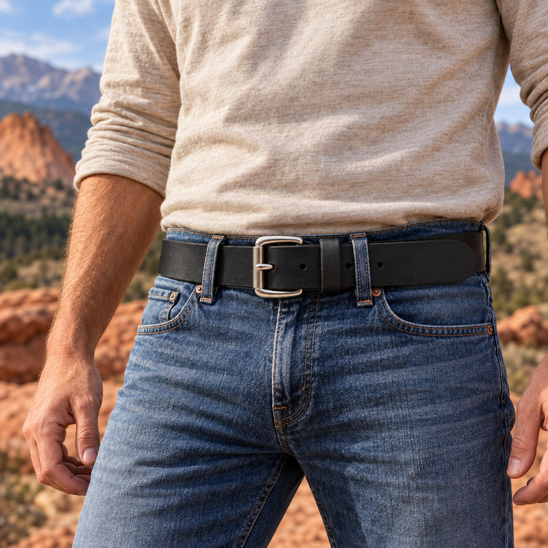 Black Crazy Horse full-grain buffalo leather belt with a Stainless Steel Roller buckle, worn with blue jeans outdoors.