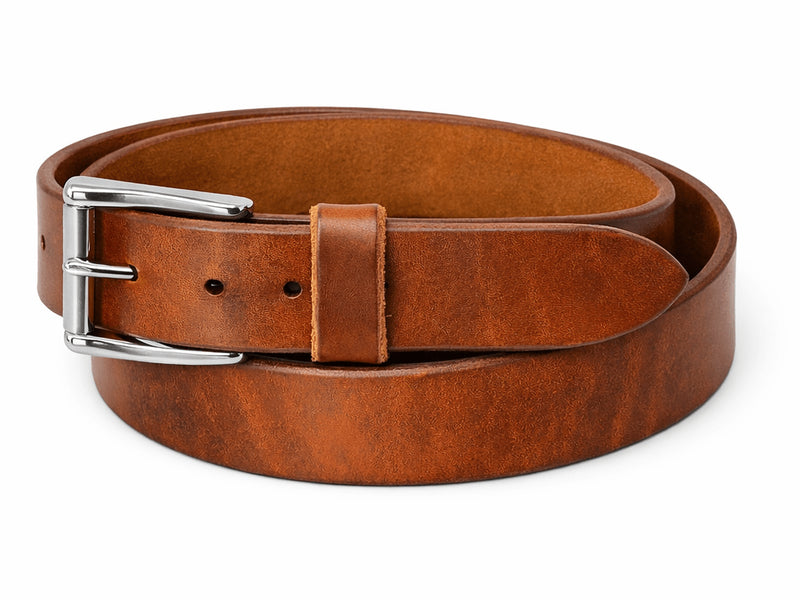 Russet harness leather belt coiled with a silver roller buckle and matching leather keeper.