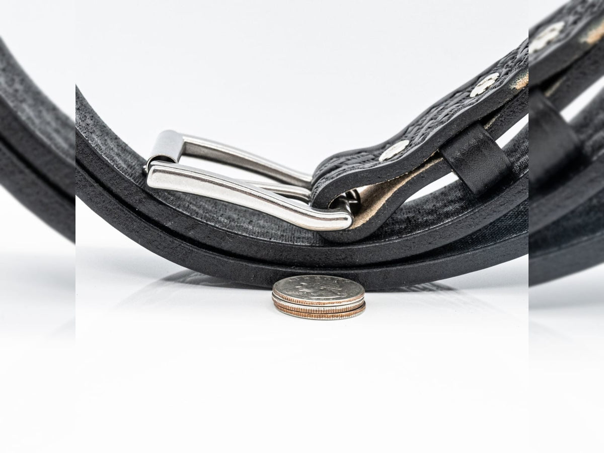 1.5 inch full grain harness leather basket weave belt coiled to show embossed pattern and removable roller buckle.