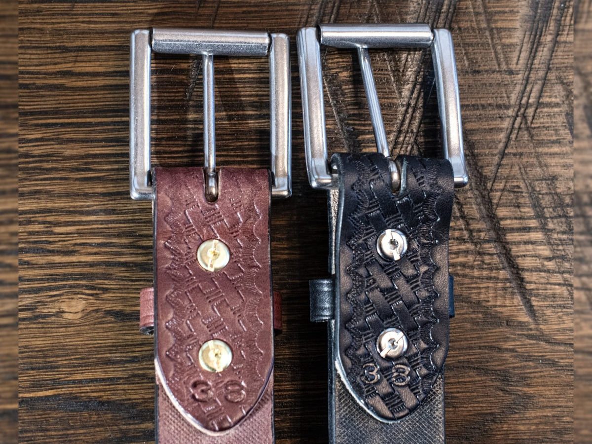 Back of 1.5 inch full grain harness leather basket weave belt showing removable roller buckle attachment and matching leather keeper.