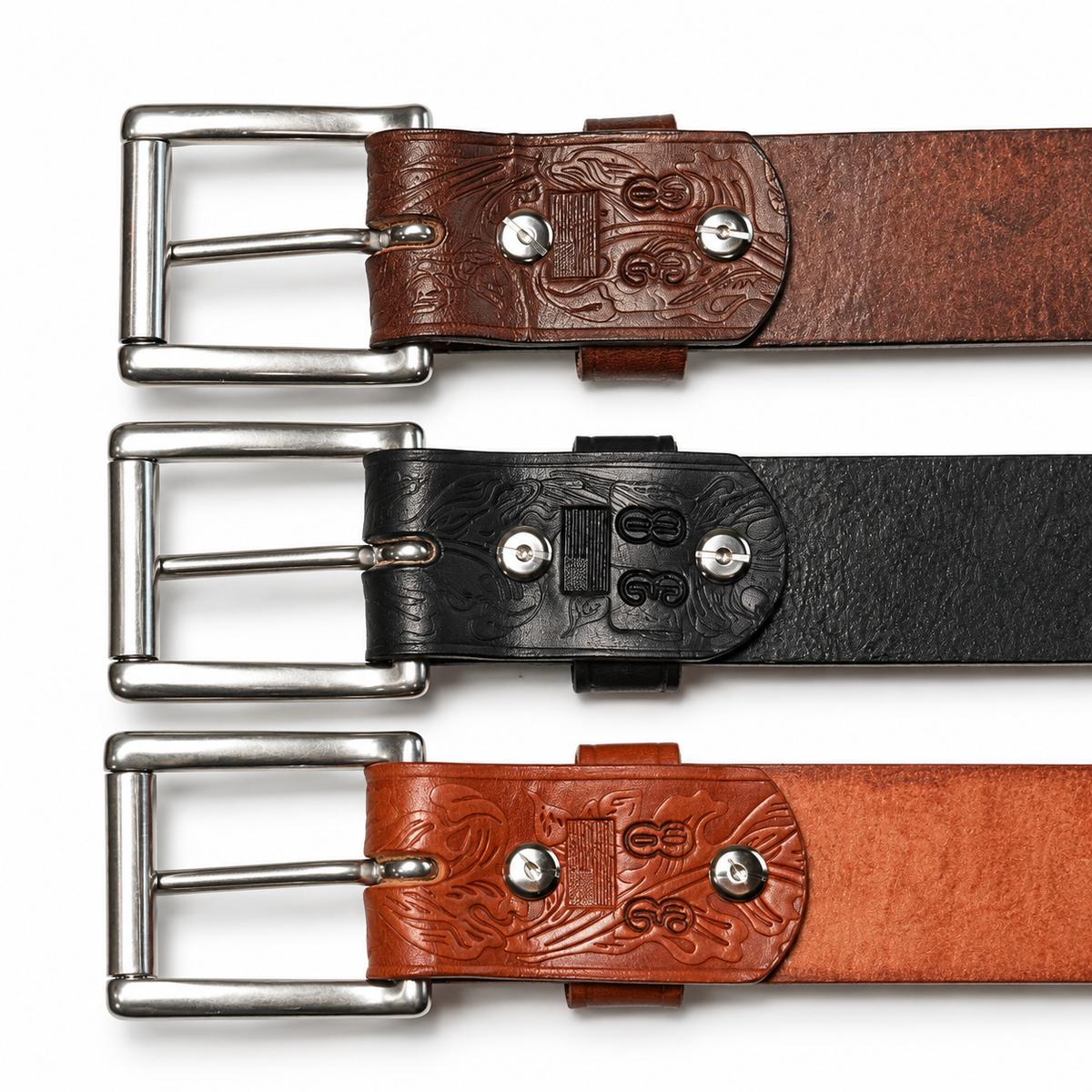 Backs of brown, black, and tan leather belt buckles showing the removable stainless steel Chicago screw attachments.