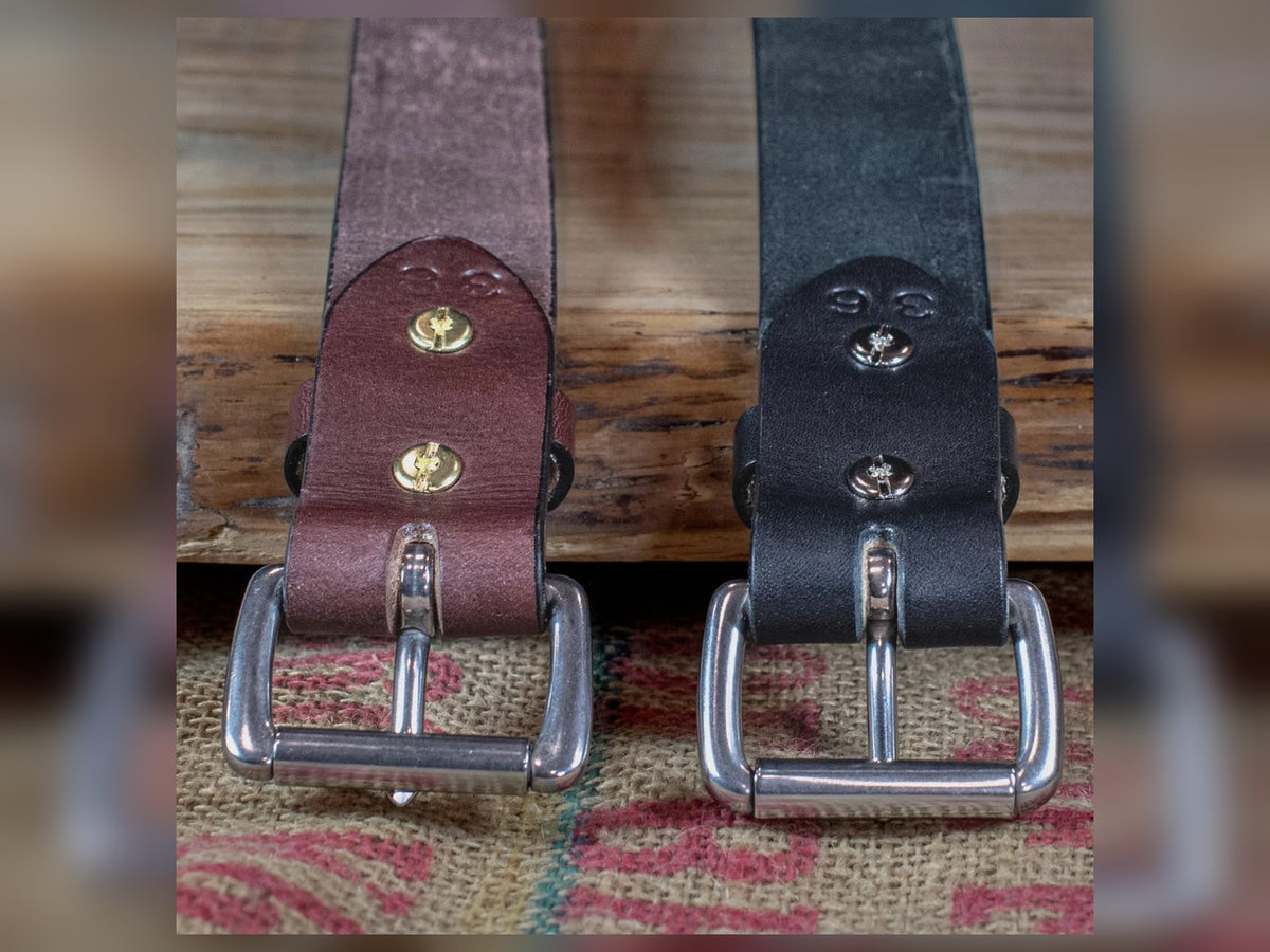 Back of black and brown Workhorse belts showing removable roller buckles secured with Chicago screws and leather keepers.